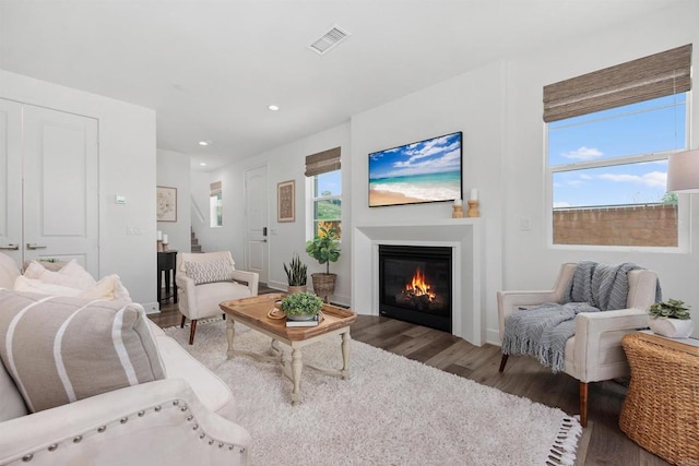 3002 Villeta Ave, Carlsbad, CA 92010 - living area featuring wood finished floors, a glass covered fireplace, recessed lighting, and stairway