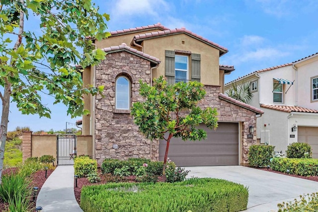 3002 Villeta Ave, Carlsbad, CA 92010 - mediterranean / spanish home featuring stucco siding, stone siding, a tiled roof, and a gate