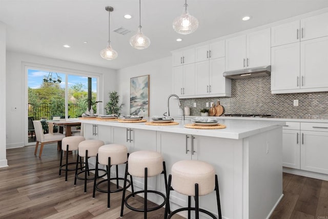 3002 Villeta Ave, Carlsbad, CA 92010 - kitchen featuring under cabinet range hood, backsplash, light countertops, dark wood-style flooring, and recessed lighting