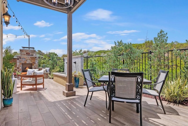 3002 Villeta Ave, Carlsbad, CA 92010 - wooden deck with an outdoor stone fireplace, a patio area, and outdoor dining space