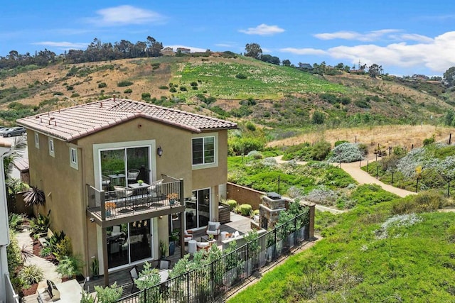 3002 Villeta Ave, Carlsbad, CA 92010 - rear view of house with stucco siding, a tile roof, and a balcony