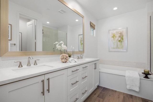 3002 Villeta Ave, Carlsbad, CA 92010 - bathroom featuring double vanity, a bath, a shower stall, wood finished floors, and recessed lighting