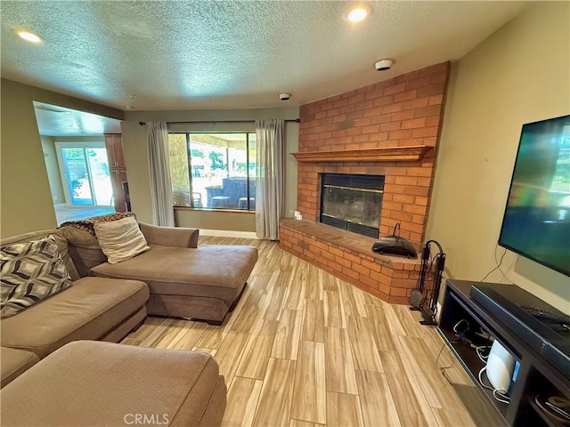 9150 Boxwood Ave, Fontana, CA 92335 - living area with a textured ceiling, a fireplace, light wood-type flooring, and recessed lighting
