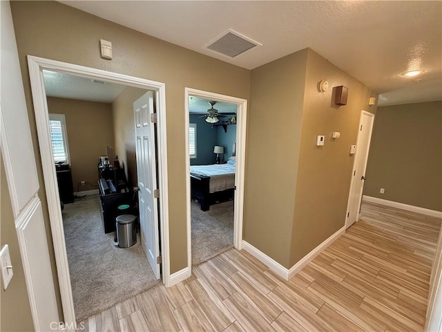 9150 Boxwood Ave, Fontana, CA 92335 - corridor featuring light wood finished floors and baseboards