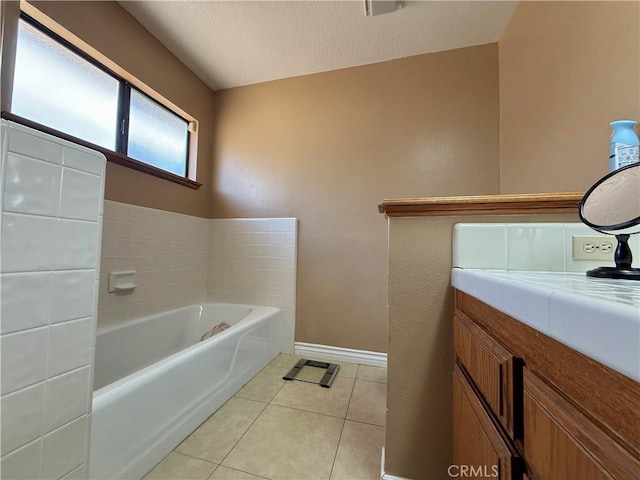 9150 Boxwood Ave, Fontana, CA 92335 - full bathroom with a bath, tile patterned flooring, vanity, and a textured ceiling