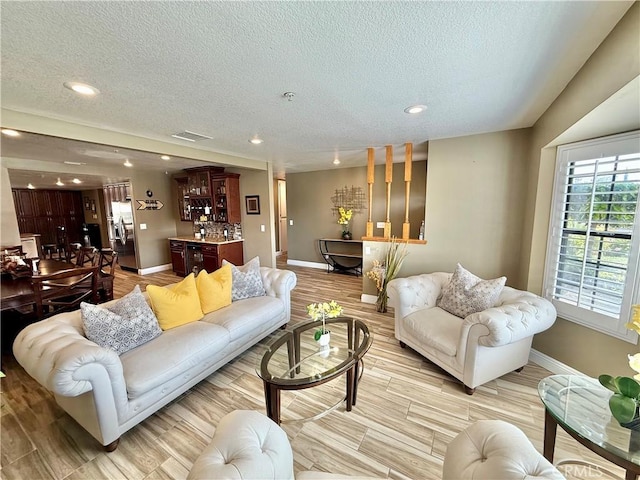 9150 Boxwood Ave, Fontana, CA 92335 - living area with a textured ceiling, recessed lighting, and light wood-style floors
