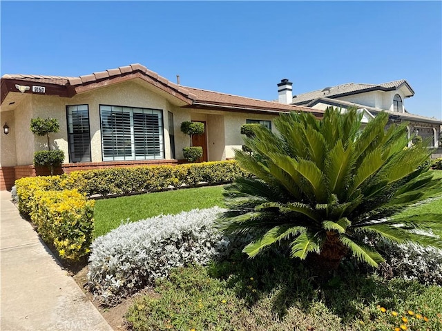 9150 Boxwood Ave, Fontana, CA 92335 - ranch-style home with stucco siding and a chimney