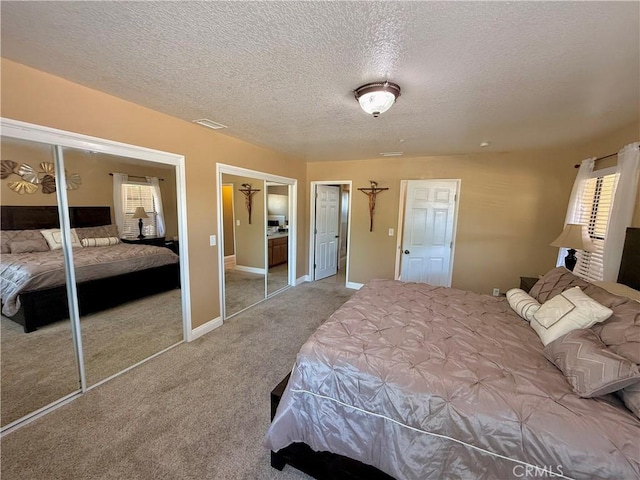 9150 Boxwood Ave, Fontana, CA 92335 - bedroom featuring a textured ceiling, two closets, and carpet floors