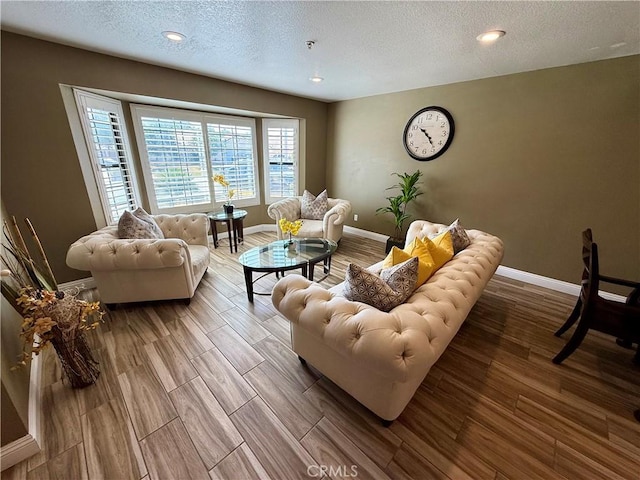 9150 Boxwood Ave, Fontana, CA 92335 - living area featuring a textured ceiling, wood finished floors, and recessed lighting