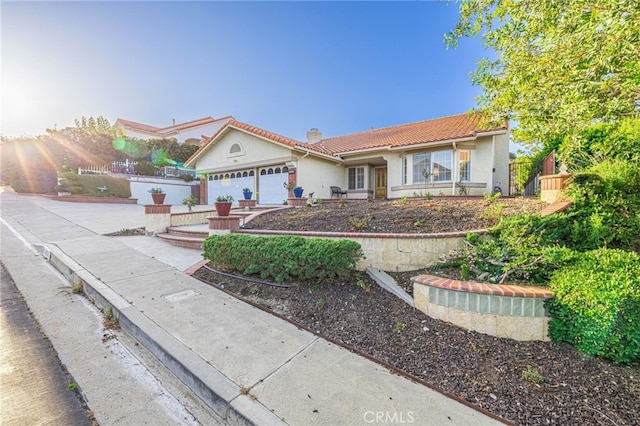 19809 Winged Foot Way, Porter Ranch, CA 91326 - view of front facade featuring a chimney, an attached garage, a tile roof, stucco siding, and driveway
