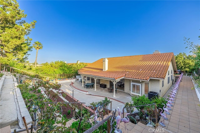 19809 Winged Foot Way, Porter Ranch, CA 91326 - rear view of property featuring a tiled roof, a chimney, stucco siding, a patio, and a fenced backyard