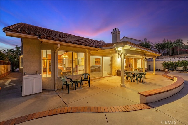 19809 Winged Foot Way, Porter Ranch, CA 91326 - rear view of property with a chimney, a patio area, outdoor dining area, a tiled roof, and stucco siding