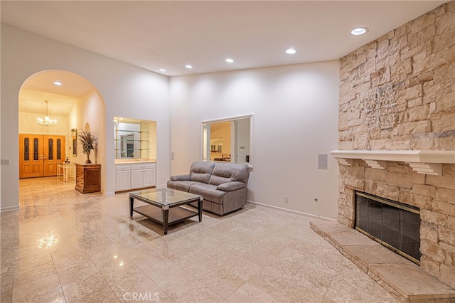 19809 Winged Foot Way, Porter Ranch, CA 91326 - living room with arched walkways, recessed lighting, a fireplace, a towering ceiling, and a chandelier
