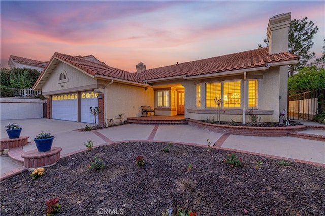 19809 Winged Foot Way, Porter Ranch, CA 91326 - view of front facade featuring a chimney, an attached garage, concrete driveway, stucco siding, and a porch