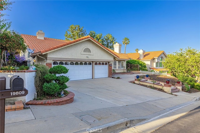 19809 Winged Foot Way, Porter Ranch, CA 91326 - view of front facade with a chimney, a garage, concrete driveway, and stucco siding