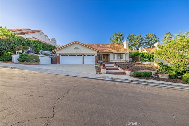 19809 Winged Foot Way, Porter Ranch, CA 91326 - view of front facade featuring a chimney, a tiled roof, a garage, driveway, and stucco siding