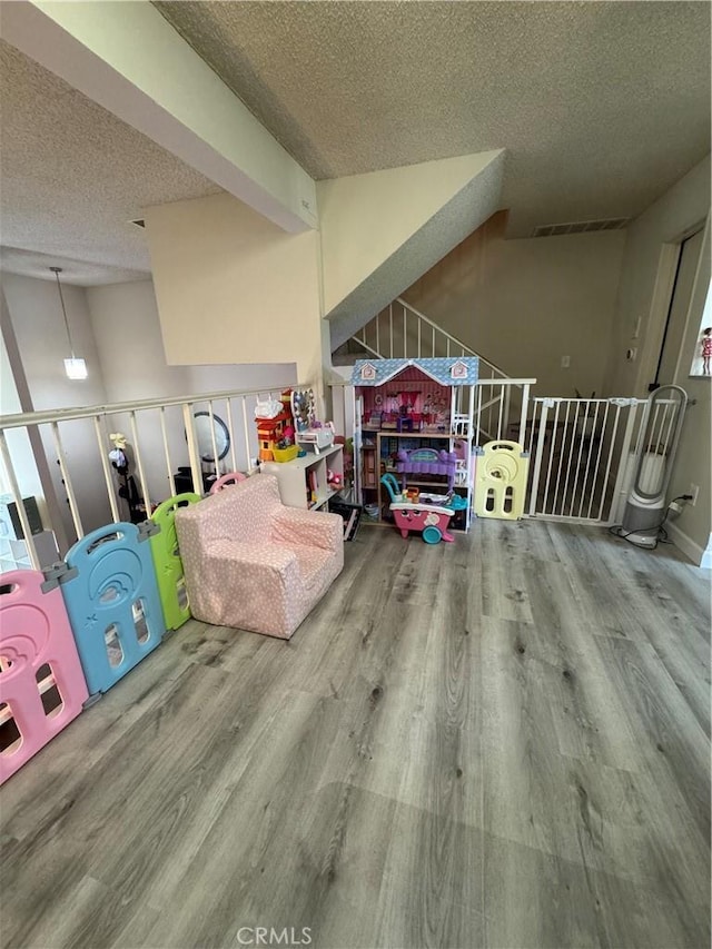 300 N Isabel St Unit 21, Glendale, CA 91206 - playroom featuring a textured ceiling and wood finished floors