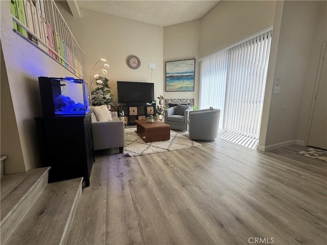 300 N Isabel St Unit 21, Glendale, CA 91206 - living area with wood finished floors, a textured ceiling, and stairway