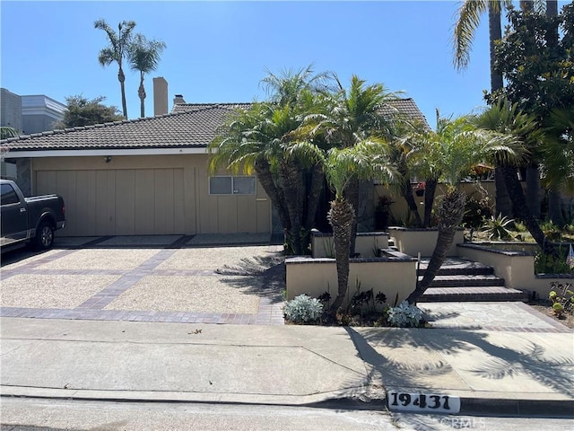 19431 Worchester Ln, Huntington Beach, CA 92646 - view of front of property with a tiled roof, driveway, a chimney, and a garage