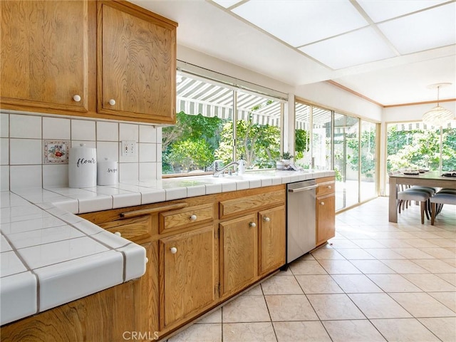 9386 Cambridge St, Cypress, CA 90630 - kitchen featuring dishwasher, healthy amount of natural light, backsplash, and light tile patterned flooring