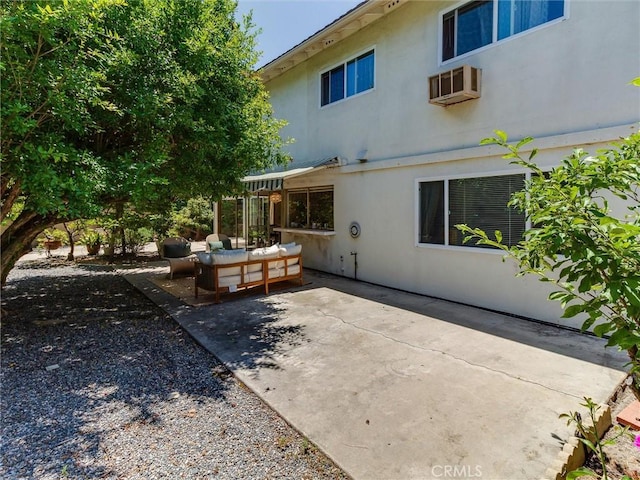 9386 Cambridge St, Cypress, CA 90630 - rear view of property with a patio area, stucco siding, an outdoor living space, and a wall unit AC