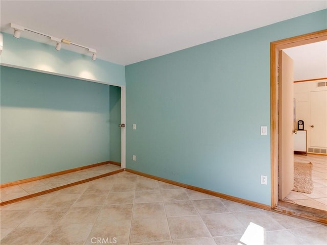9386 Cambridge St, Cypress, CA 90630 - empty room featuring rail lighting and tile patterned flooring