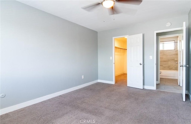 280 W S St, Rialto, CA 92376 - unfurnished bedroom featuring carpet flooring, a walk in closet, a closet, and ceiling fan