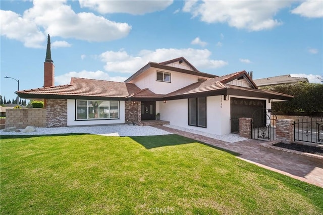19040 Celtic St, Porter Ranch, CA 91326 - view of front facade with stucco siding, a garage, a chimney, and a gate