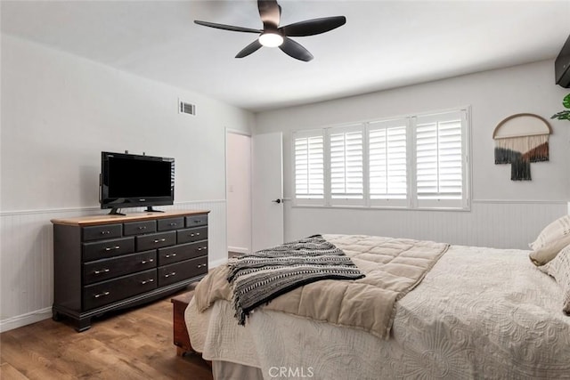 330 Spruce St, Riverside, CA 92507 - bedroom with a wainscoted wall, wood finished floors, and a ceiling fan