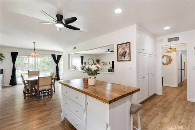 330 Spruce St, Riverside, CA 92507 - kitchen featuring wood counters, ceiling fan, white cabinets, light wood-type flooring, and pendant lighting