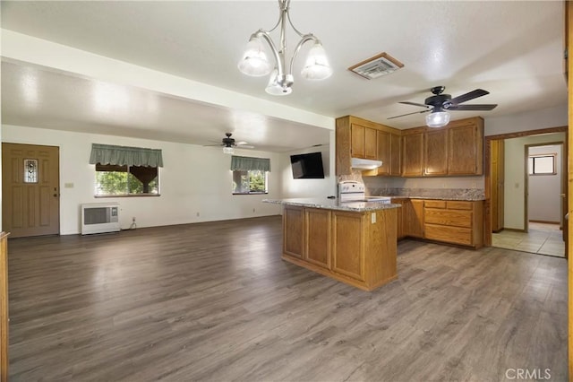 8140 Sherwood Blvd, Los Molinos, CA 96055 - kitchen featuring ceiling fan, under cabinet range hood, stove, and heating unit