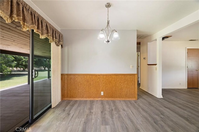 8140 Sherwood Blvd, Los Molinos, CA 96055 - empty room with a wainscoted wall, wood finished floors, a chandelier, and wooden walls