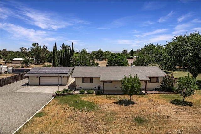 8140 Sherwood Blvd, Los Molinos, CA 96055 - ranch-style house featuring roof mounted solar panels, driveway, and an attached garage