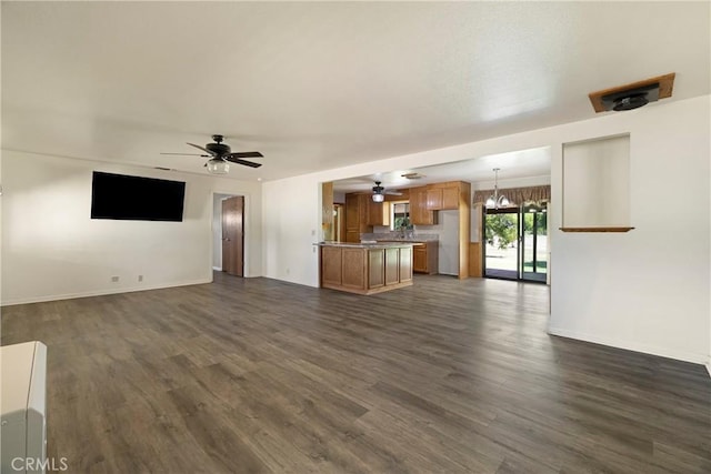 8140 Sherwood Blvd, Los Molinos, CA 96055 - unfurnished living room with dark wood-style flooring, ceiling fan, and a chandelier