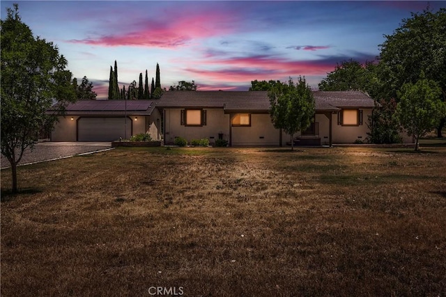 8140 Sherwood Blvd, Los Molinos, CA 96055 - ranch-style house with a garage, solar panels, a front lawn, and dirt driveway