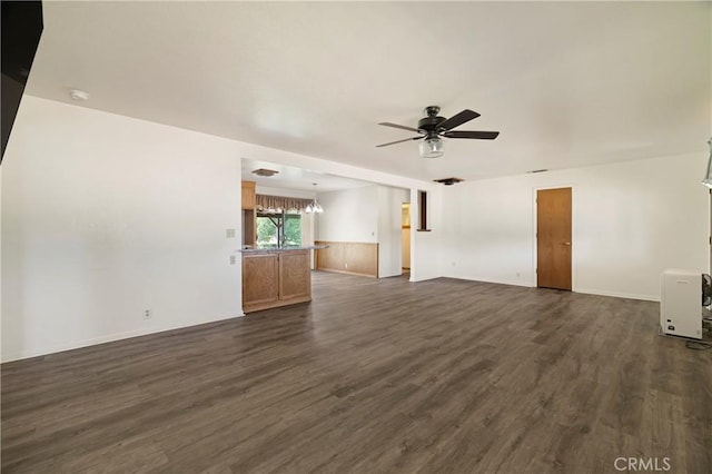 8140 Sherwood Blvd, Los Molinos, CA 96055 - unfurnished living room featuring a ceiling fan, a chandelier, and dark wood-style flooring