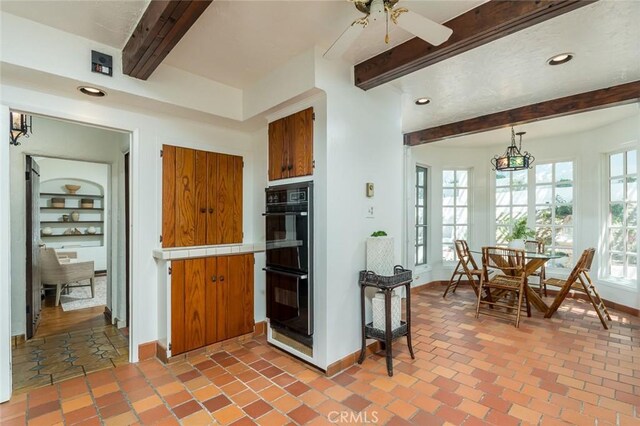 611 E Mountain St, Glendale, CA 91207 - kitchen with beam ceiling, tile countertops, brown cabinetry, a ceiling fan, and recessed lighting