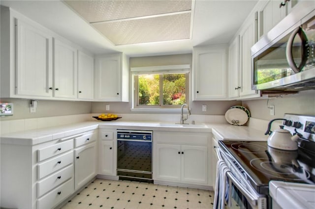 31214 W Nine Dr, Laguna Niguel, CA 92677 - kitchen featuring stainless steel appliances, light floors, white cabinets, and tile counters