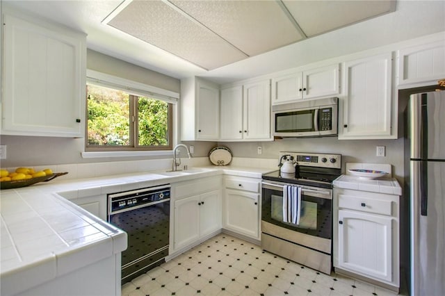 31214 W Nine Dr, Laguna Niguel, CA 92677 - kitchen featuring stainless steel appliances, tile countertops, and white cabinetry