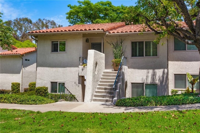 31214 W Nine Dr, Laguna Niguel, CA 92677 - mediterranean / spanish house with stucco siding, a tiled roof, stairs, and a front yard