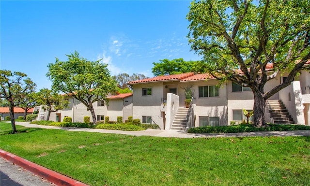 31214 W Nine Dr, Laguna Niguel, CA 92677 - view of front of property featuring stairs, a front yard, stucco siding, and a tiled roof