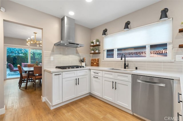 6207 Capistrano Ave, Woodland Hills, CA 91367 - kitchen with stainless steel appliances, wall chimney exhaust hood, open shelves, light wood finished floors, and recessed lighting