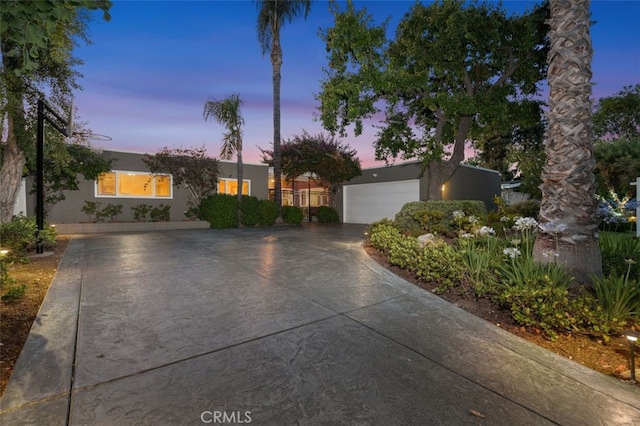 6207 Capistrano Ave, Woodland Hills, CA 91367 - view of front of house featuring a garage, stucco siding, and driveway