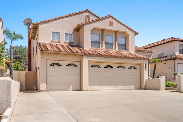 15280 Dunes Way, Moreno Valley, CA 92555 - mediterranean / spanish house featuring a garage, concrete driveway, stucco siding, and a tile roof