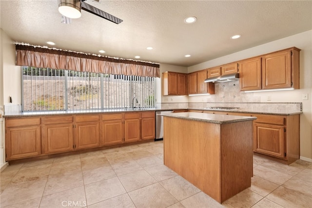 15280 Dunes Way, Moreno Valley, CA 92555 - kitchen with appliances with stainless steel finishes, under cabinet range hood, recessed lighting, a center island, and decorative backsplash