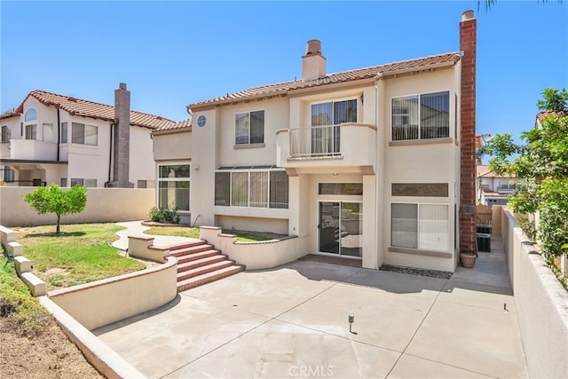 15280 Dunes Way, Moreno Valley, CA 92555 - rear view of house with a chimney, a tile roof, and stucco siding