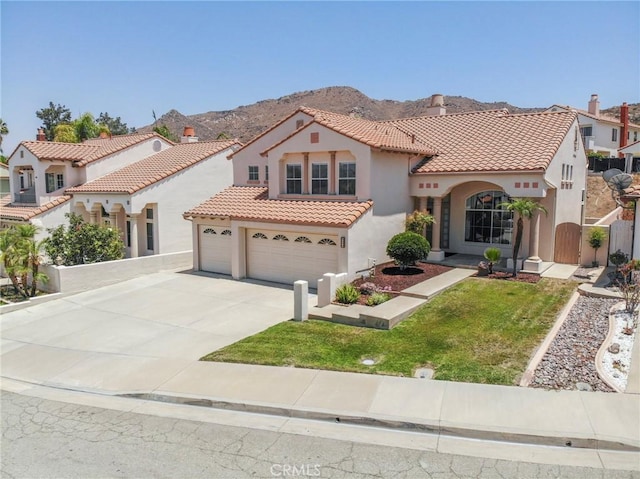 15280 Dunes Way, Moreno Valley, CA 92555 - mediterranean / spanish house with stucco siding, a tiled roof, concrete driveway, and a mountain view