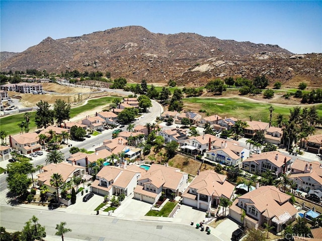 15280 Dunes Way, Moreno Valley, CA 92555 - aerial overview of property's location with mountains, nearby suburban area, and a golf club