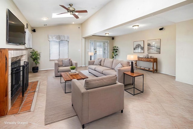 3329 Mandy Ln, Spring Valley, CA 91977 - living area with a tile fireplace, ceiling fan, lofted ceiling, light tile patterned floors, and a skylight