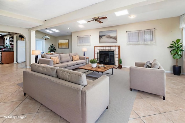 3329 Mandy Ln, Spring Valley, CA 91977 - living room with light tile patterned floors, a fireplace, arched walkways, ceiling fan, and recessed lighting